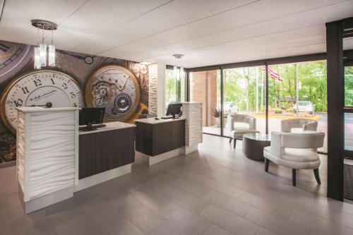 a store with a large clock on the wall at La Quinta by Wyndham Sturbridge in Sturbridge