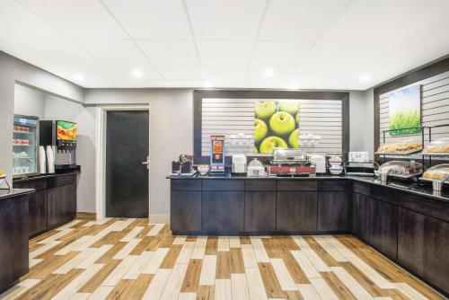 a fast food restaurant with a counter with food at La Quinta Inn & Suites by Wyndham DC Metro Capital Beltway in Capitol Heights