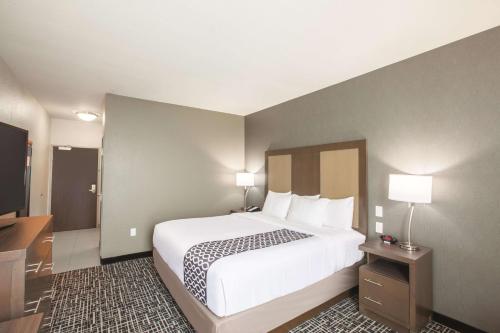 a hotel room with a bed and a television at La Quinta by Wyndham San Marcos Outlet Mall in San Marcos