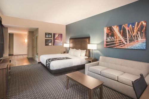 a hotel room with a bed and a couch at La Quinta by Wyndham Chicago Downtown in Chicago
