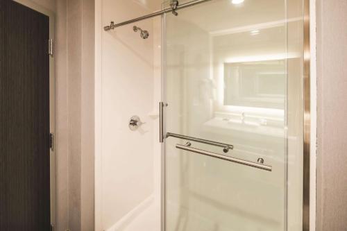 a bathroom with a shower with a glass door at La Quinta Inn & Suites by Wyndham Atlanta South - McDonough in McDonough