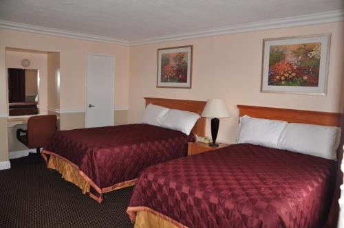 a hotel room with two beds and a desk at Americas Best Value Inn - Downtown Oakland/Lake Merritt in Oakland