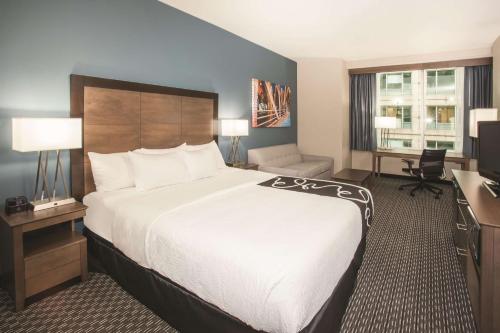 a hotel room with a large bed and a desk at La Quinta by Wyndham Chicago Downtown in Chicago