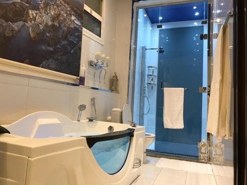 a bathroom with a tub and a sink and a shower at Deluxe Furnished Apartments in Taif