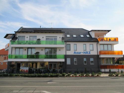 a large white building with a black roof at Alpha Apartman Sárvár in Sárvár