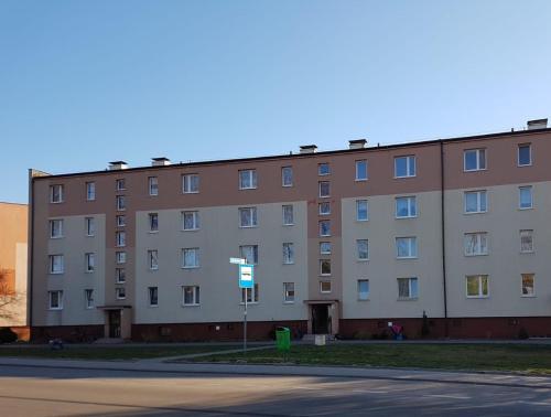 an apartment building on the corner of a street at Fok Sztormowy in Hel