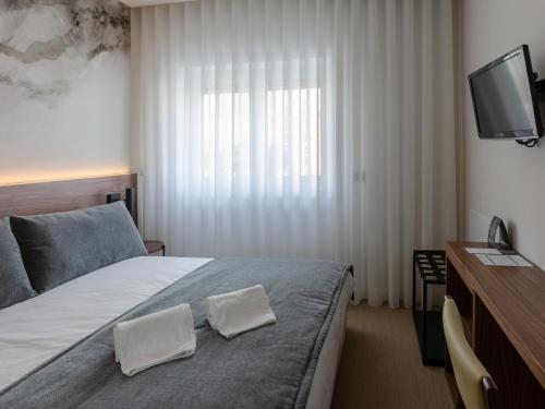 Postel nebo postele na pokoji v ubytování Hotel Afonso V & SPA