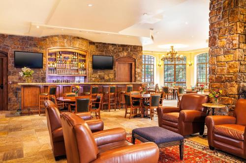 a bar in a restaurant with tables and chairs at Tivoli Lodge in Vail