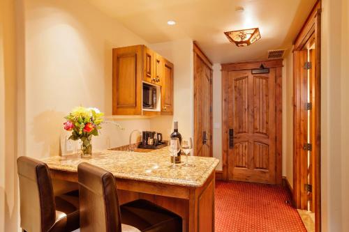 a kitchen with a table with a vase of flowers at Tivoli Lodge in Vail