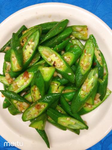 a plate of food with green beans on a table at Grand Blue Beach Hotel in Boracay