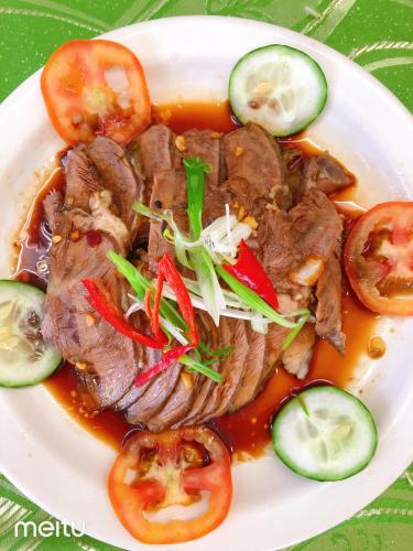 a plate of food with meat and vegetables on a table at Grand Blue Beach Hotel in Boracay