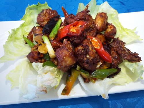 a plate of food with lettuce and meat and peppers at Grand Blue Beach Hotel in Boracay