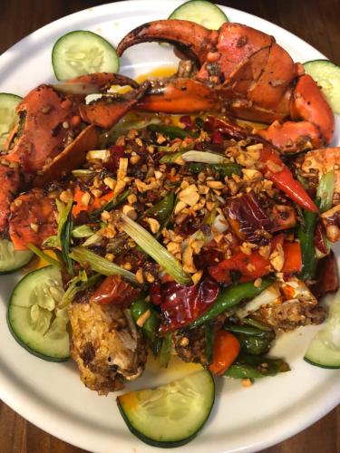 a plate of food with seafood and vegetables on a table at Grand Blue Beach Hotel in Boracay