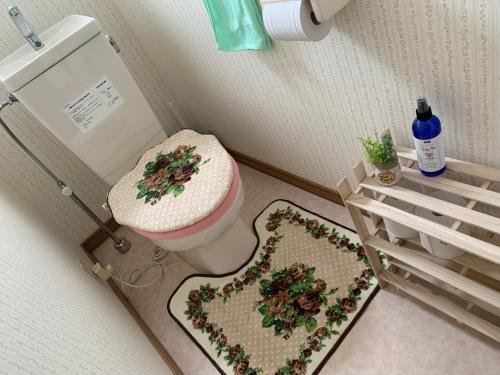 a bathroom with a toilet and two rugs on the floor at STAY Sakura in Bibai