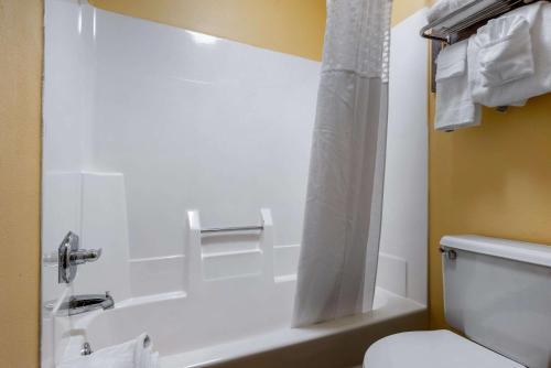 a bathroom with a tub and a toilet and a shower at Econo Lodge Lexington Southeast in Lexington
