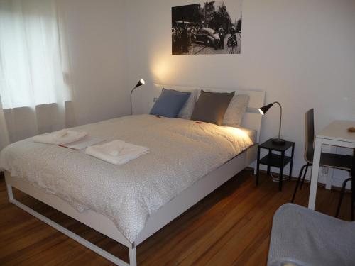 a bedroom with a bed with two towels on it at rooms lux city in Luxembourg