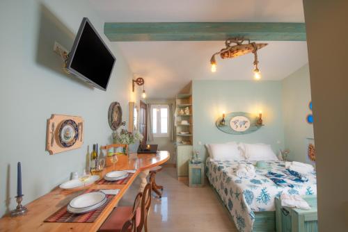 a room with a table and a bed and a dining room at Gregos Rooftop Suite City Center w. Sea View in Corfu Town