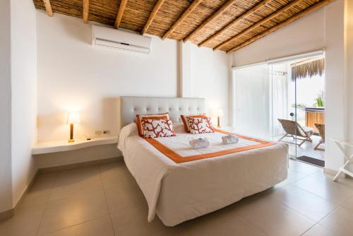 Кровать или кровати в номере Qalma Punta Sal