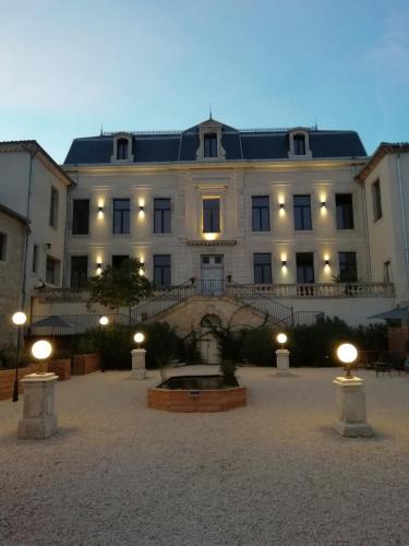 a large white building with lights in front of it at Domaine de la Vidalle in Vendres
