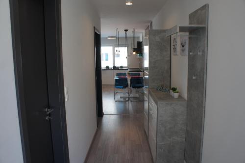 a hallway with a kitchen and a dining room at Laguna Beach Apartmanok in Siófok