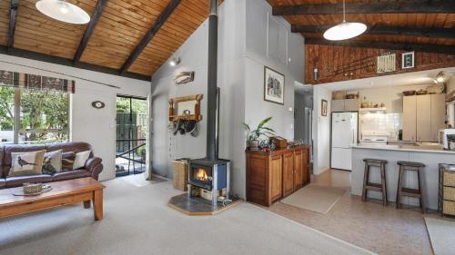 a living room with a wood stove in it at Firstcast Turangi in Turangi