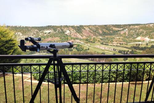 a telescope on a tripod looking at a valley at Villa HERMIONA in Kouklia