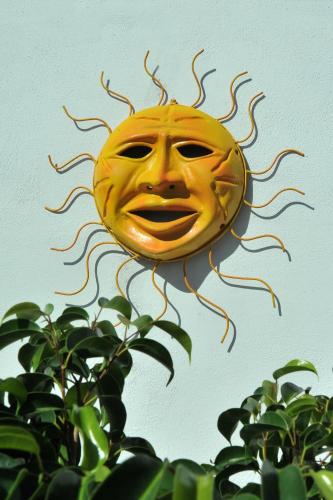 a yellow sun kite is attached to a wall at E Poi...Ravello in Ravello