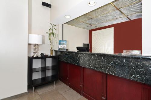 a lobby with a reception desk with a mirror at Clackamas Inn and Suites in Clackamas