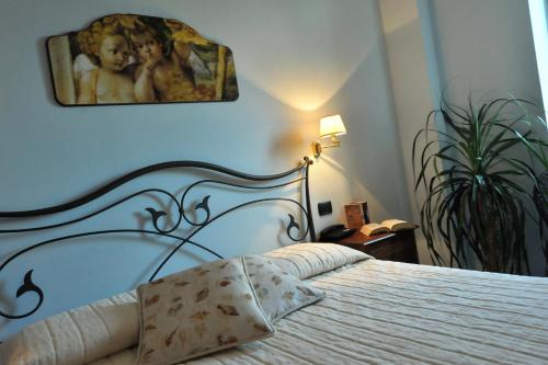 a bedroom with a bed with a painting on the wall at E Poi...Ravello in Ravello