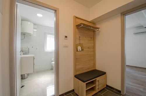 a bathroom with a bench and a toilet in it at Apartment Pula R&D in Pula