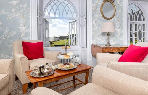 a living room with two chairs and a table at Royal Glen Hotel in Sidmouth