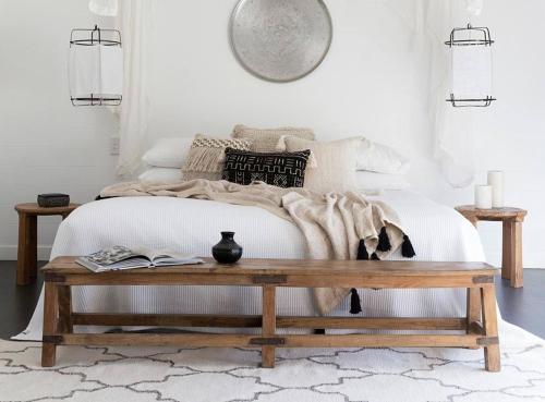 a bedroom with a bed with a wooden coffee table at Bay Lane Penthouse in Byron Bay