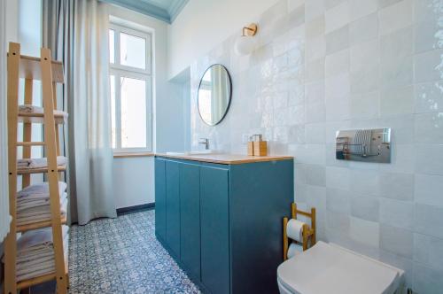 a bathroom with a blue cabinet and a toilet at Grand Apartments - Lighthouse 200 meters from the beach in Sopot