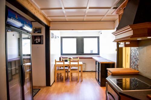 a kitchen and dining room with a table and chairs at Trolltunga/Folgefonna Camp house in Jondal
