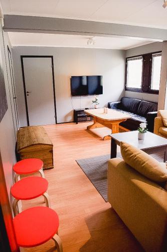 a living room with a couch and a table at Trolltunga/Folgefonna Camp house in Jondal