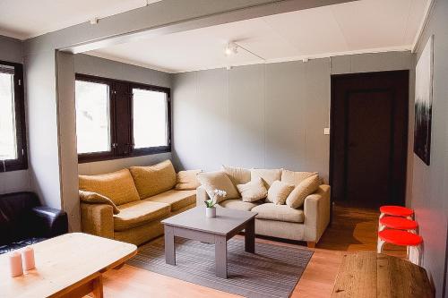 a living room with a couch and a table at Trolltunga/Folgefonna Camp house in Jondal