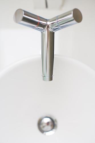 a chrome plated metal letter t on a white background at MAFF Top Studio Apartment in The Hague