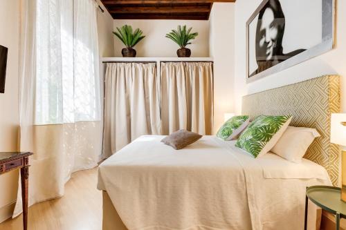 a bedroom with a bed and a window at Trevi Chic House in Rome