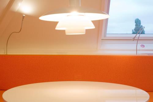 a room with a table and a light and a window at MAFF Top Studio Apartment in The Hague