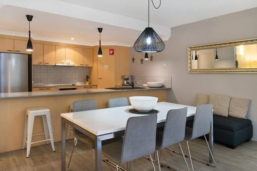 a kitchen and dining room with a table and chairs at Indiah in Byron Bay