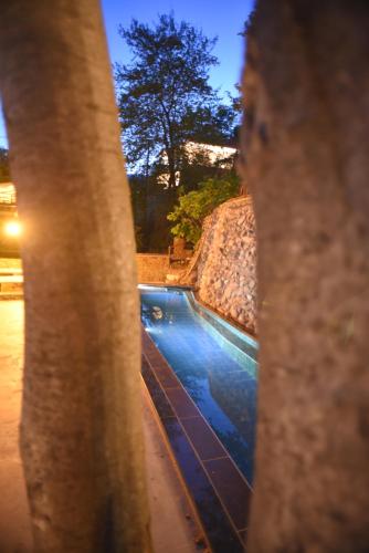 a view of a swimming pool seen through a window at Santa Marina Guesthouse in Kato Loutraki