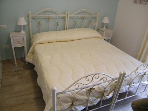 a bedroom with a white bed with two night stands at B&B Il Cantuccio in Fondi