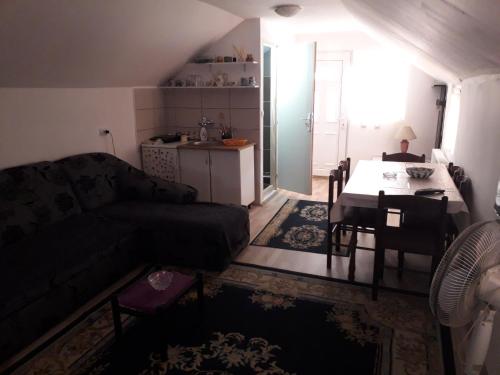 a living room with a couch and a table at Guest House Vila Banjica in Pirot