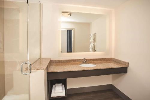 a bathroom with a sink and a mirror at La Quinta by Wyndham Chicago Downtown in Chicago