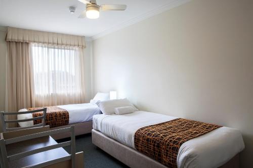 Ένα ή περισσότερα κρεβάτια σε δωμάτιο στο Mandarin Motel
