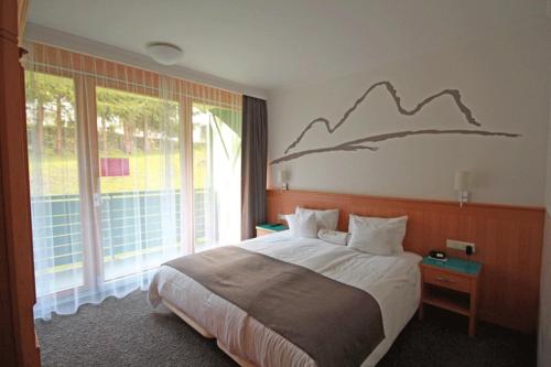 Un pat sau paturi într-o cameră la Alpine Club by Schladming-Appartements