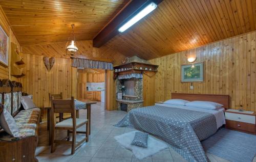 a bedroom with a bed and a table and a fireplace at Cottage Nilda I in Poreč