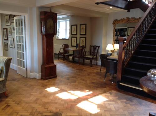 a living room with a staircase and a table and chairs at The Porlock Weir Hotel in Porlock