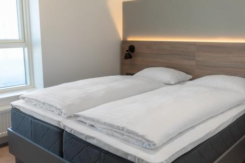 
a bed with a white comforter and pillows at Copenhagen Go Hotel in Copenhagen
