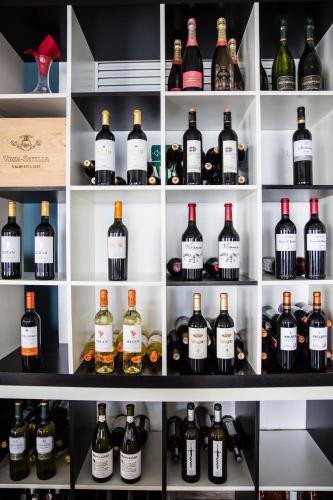 a shelf filled with lots of bottles of wine at Hotel Boutique Milla de Plata in Torreguadiaro